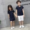 A child and child posing for a picture Description automatically generated with low confidence
