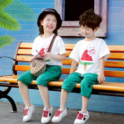 A couple of children sitting on a bench Description automatically generated with low confidence