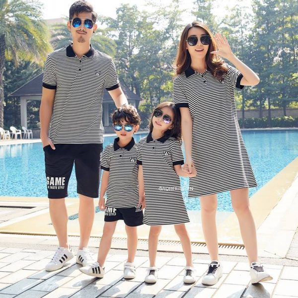A group of people posing for a photo by a pool Description automatically generated with medium confidence