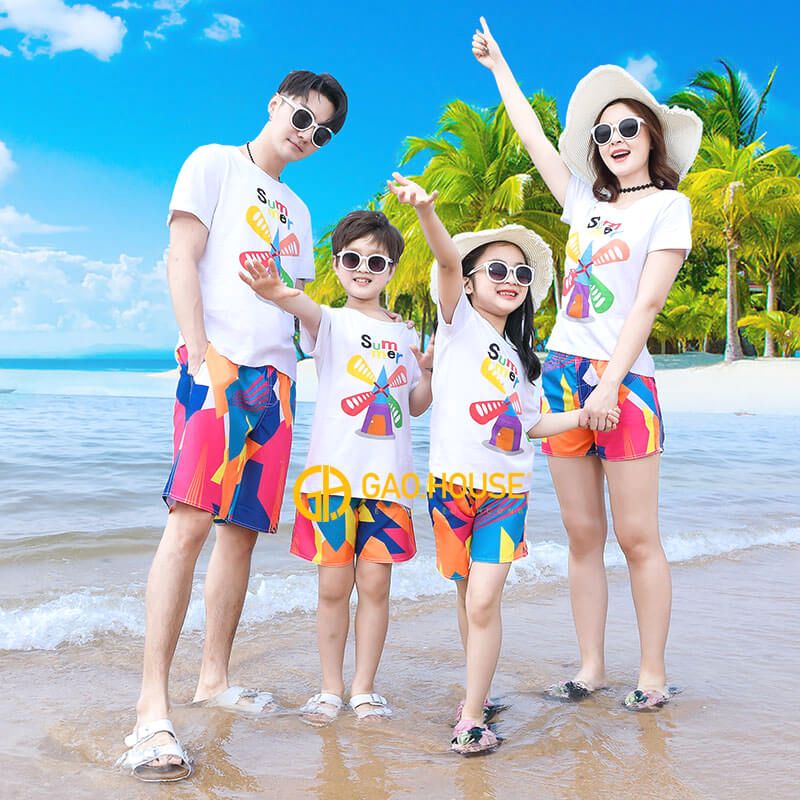 A group of people posing for a photo on a beach

Description automatically generated with medium confidence
