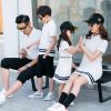 A group of people sitting on a bench Description automatically generated with medium confidence