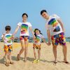 A group of people walking on a beach Description automatically generated with medium confidence