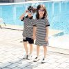 A person and a child taking a selfie in front of a pool Description automatically generated with medium confidence