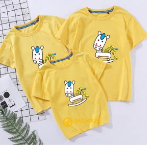 A yellow shirt with cartoon characters on it Description automatically generated with low confidence
