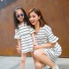 Two girls posing for a picture Description automatically generated with low confidence