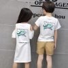 Two people standing next to each other Description automatically generated with low confidence